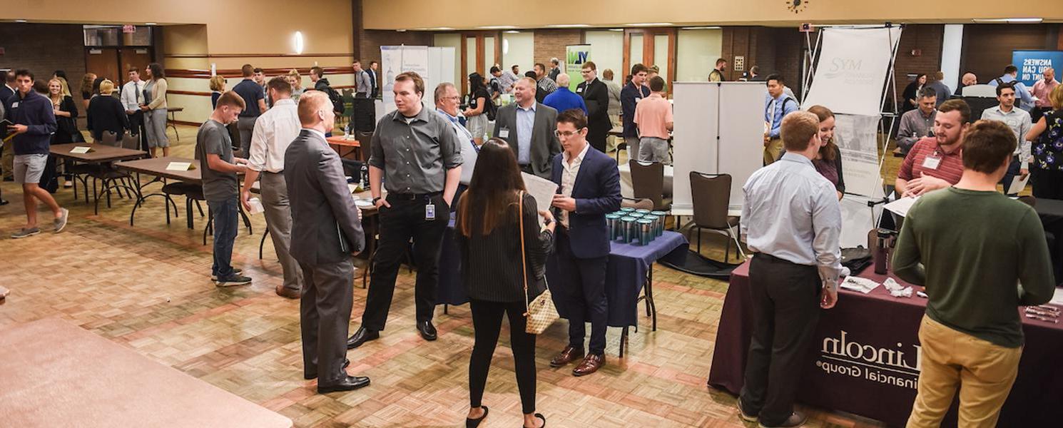 Students collecting information on careers at an accounting event on campus.